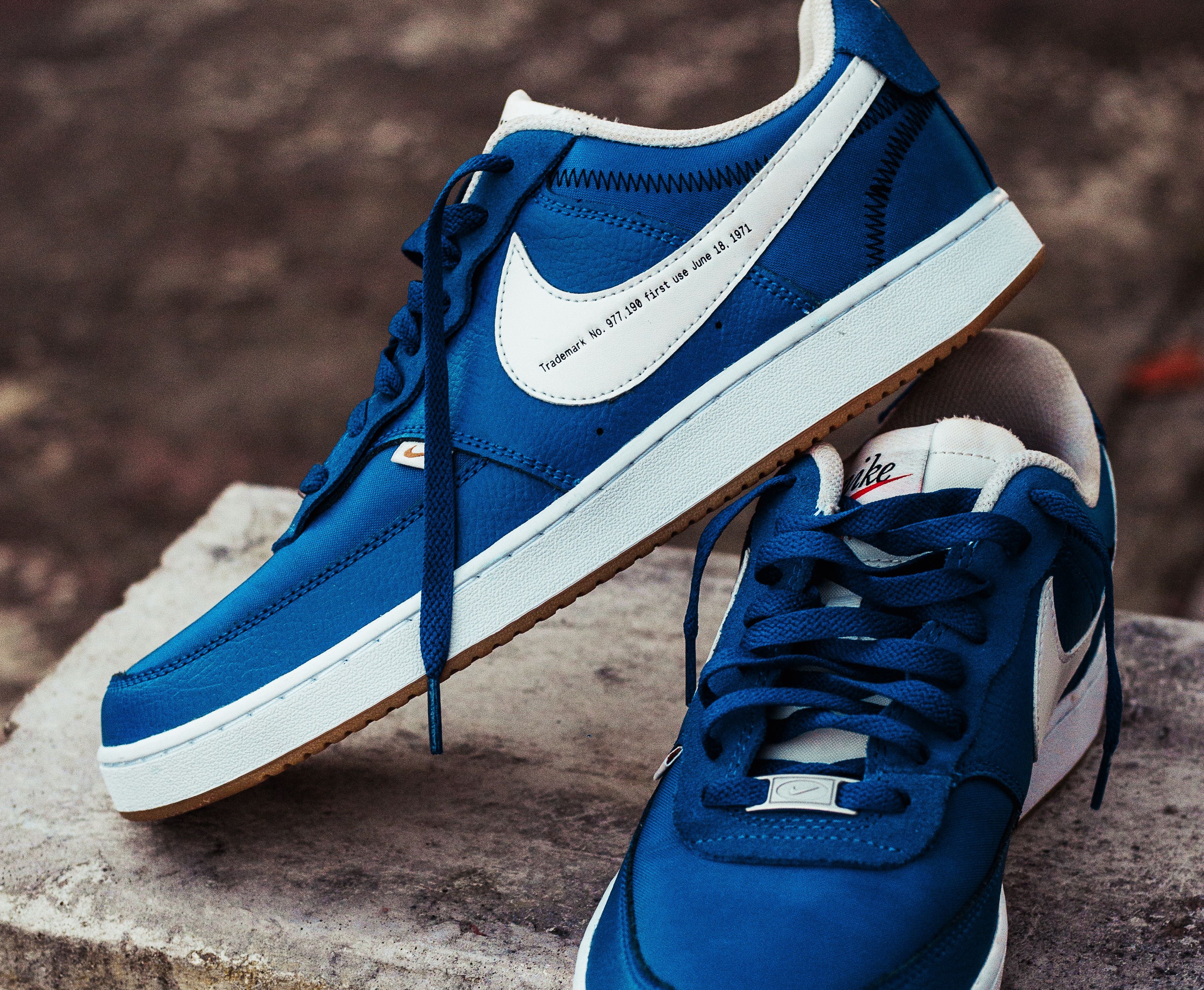 blue sneakers on stone bench with brown background